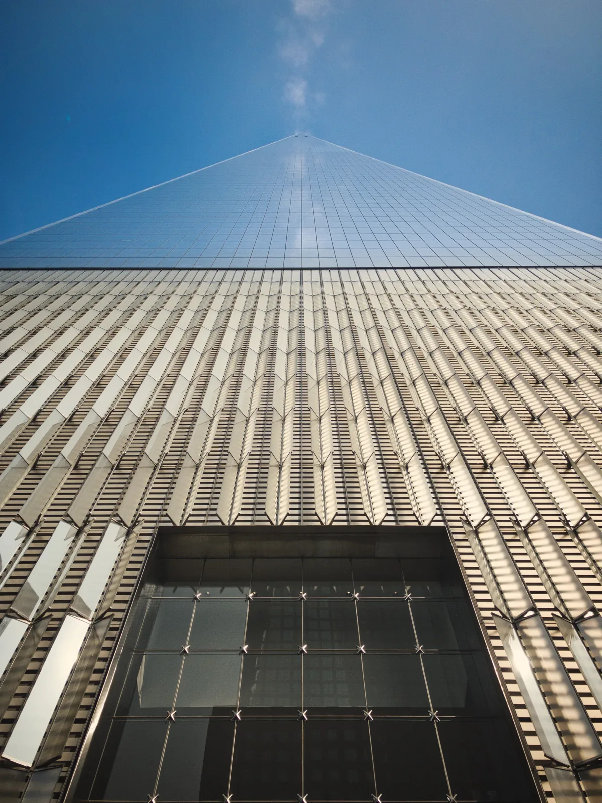 Looking up a glass-and-steel skyscraper facade