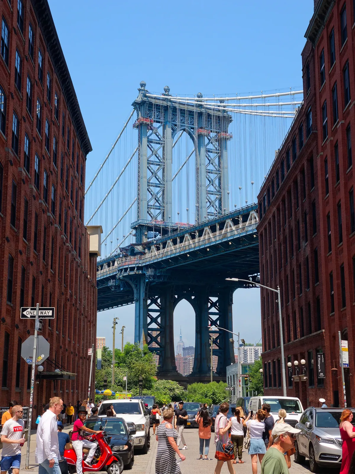 The Manhattan Bridge framed by brick buildings in DUMBO