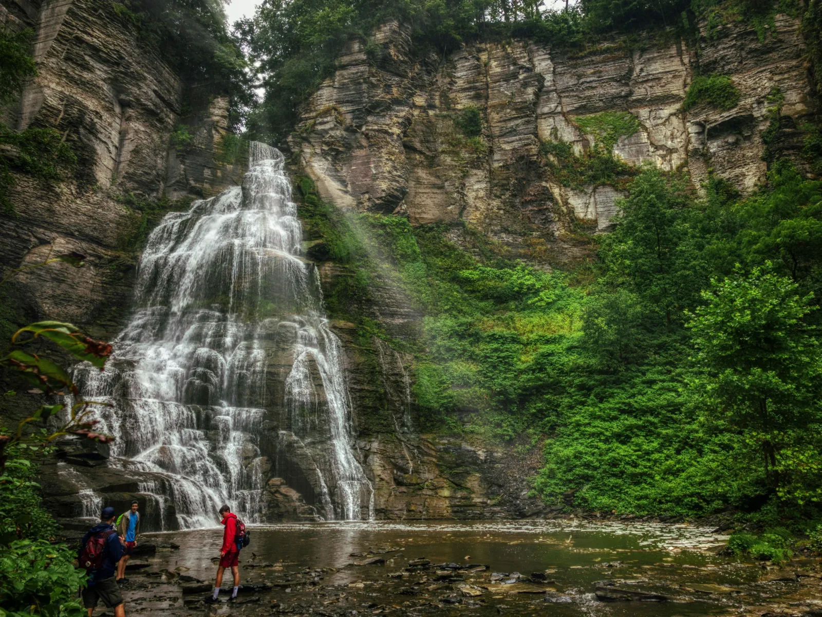 A waterfall in a green gorge