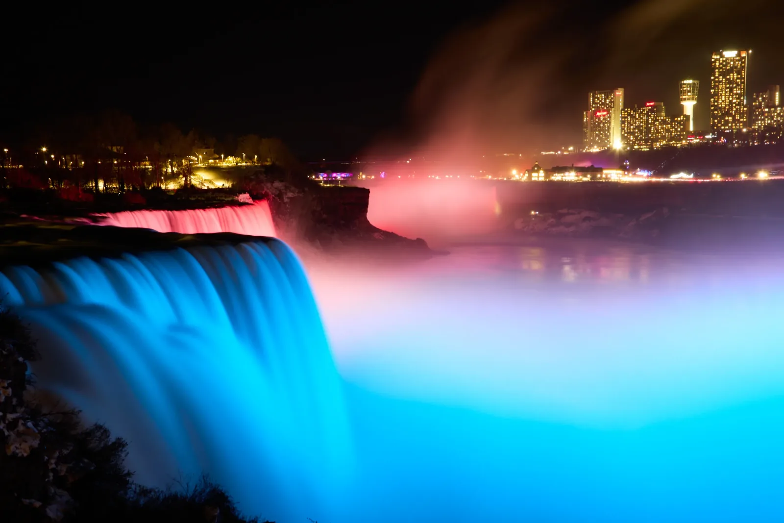 A great waterfall lit at night