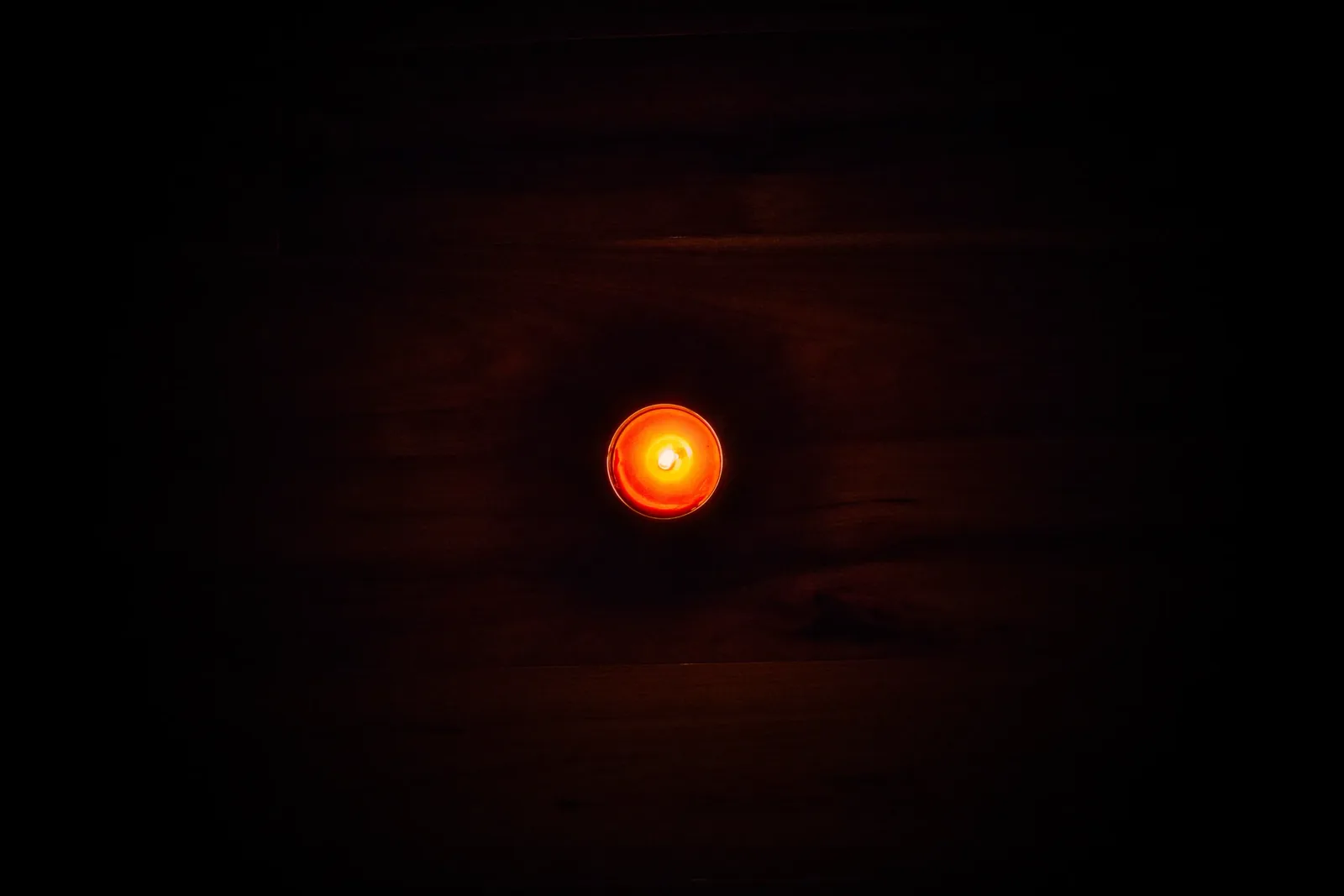A dim red glow in darkness