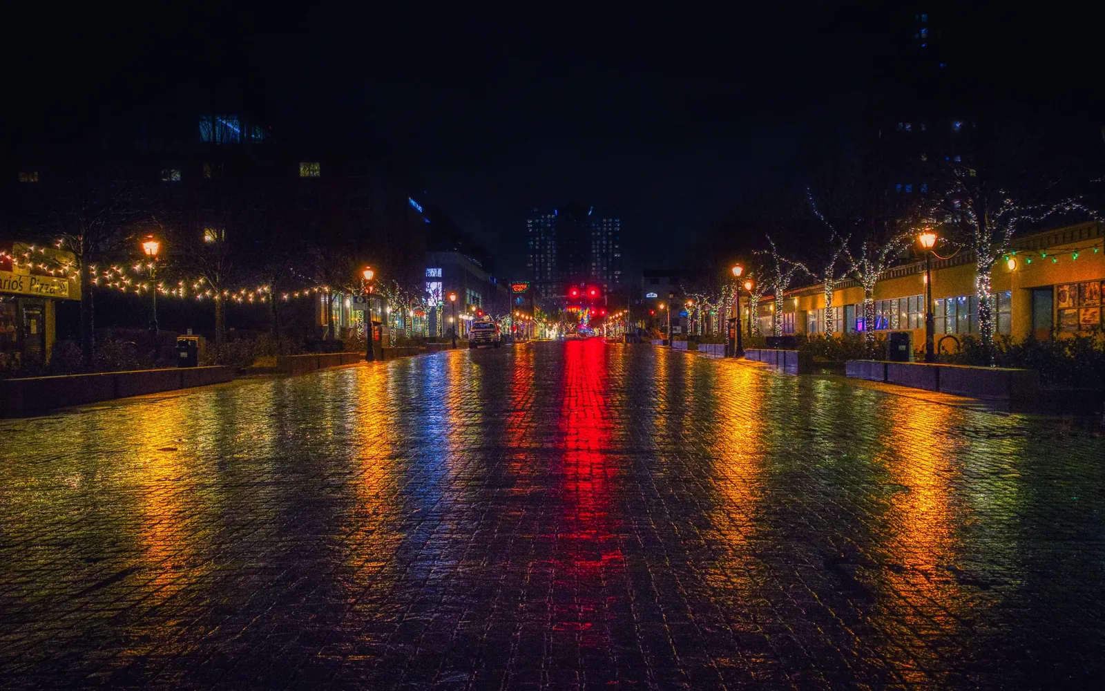 A city skyline reflected on the water at night