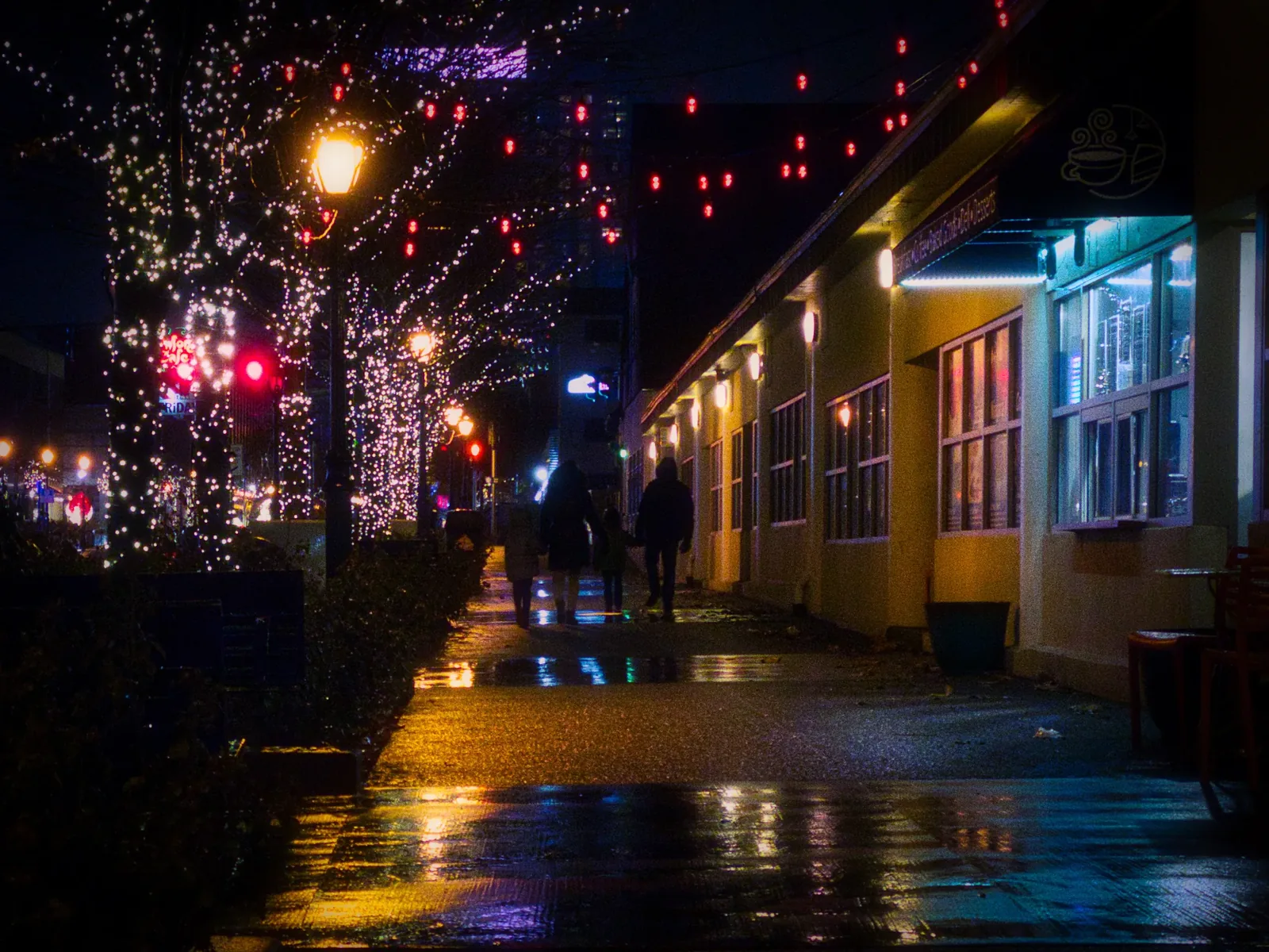 City lights on a rain-soaked street at night