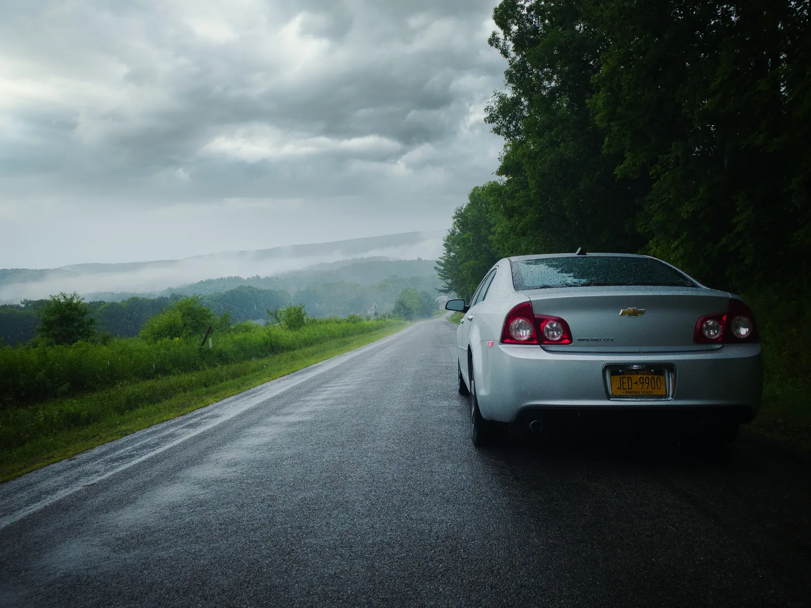 A car on an open road in autumn