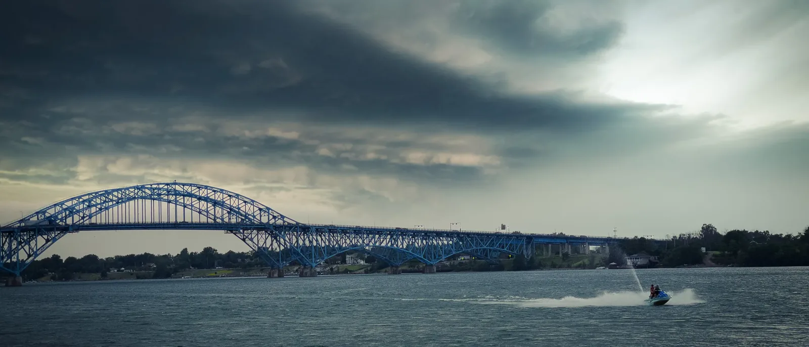 A long bridge under a moody sky