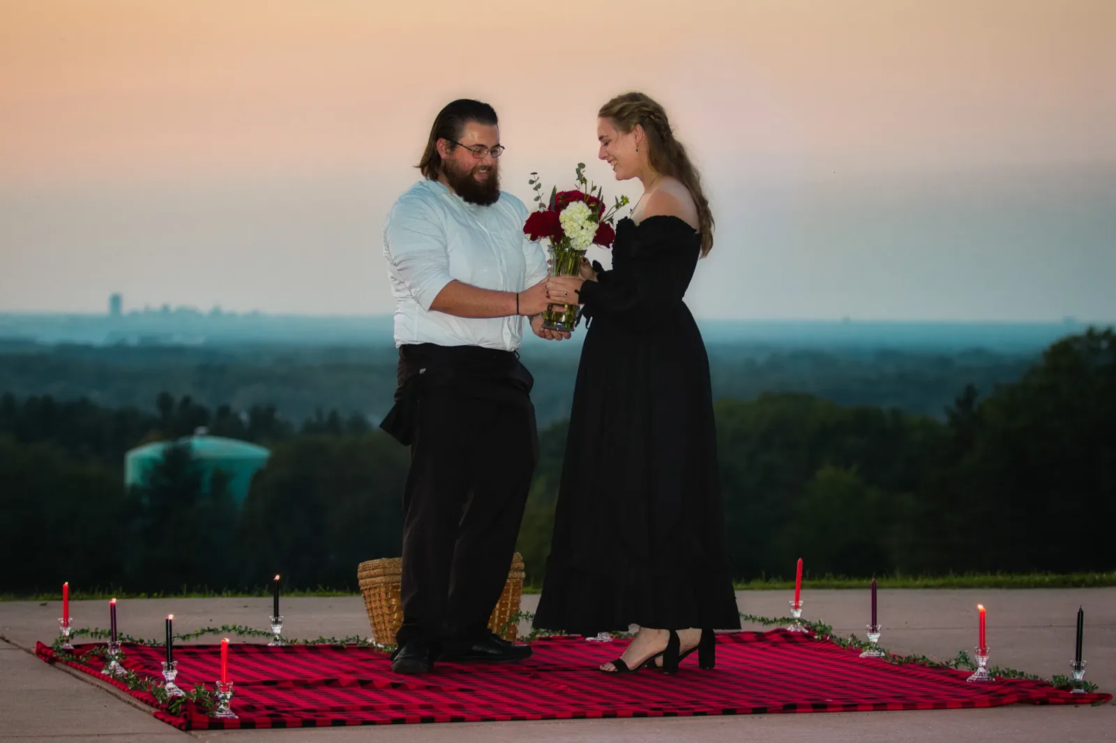 A newly engaged couple at sunset